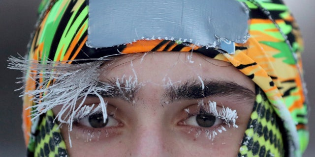 Frost covers part of the face of University of Minnesota student Daniel Dylla during a morning jog along Mississippi River Parkway Tuesday, Jan. 29, 2019, in Minneapolis.