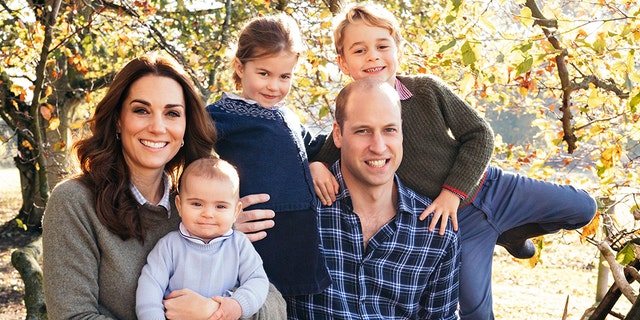 Kate Middle and Prince William pose for a photo with their three children, George (right), Charlotte (center) and Louis.