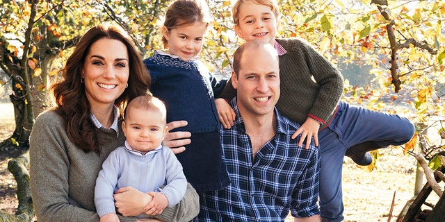 Kate Middle and Prince William pose for a photo with their three children, George (right), Charlotte (center) and Louis.