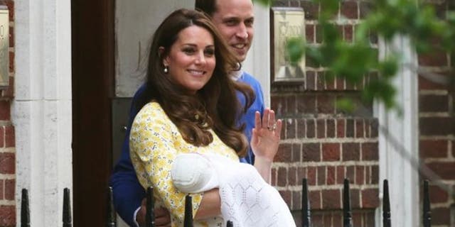 Prince William and his wife Catherine, Duchess of Cambridge, appear with their baby daughter Charlotte outside the Lindo Wing of St Mary