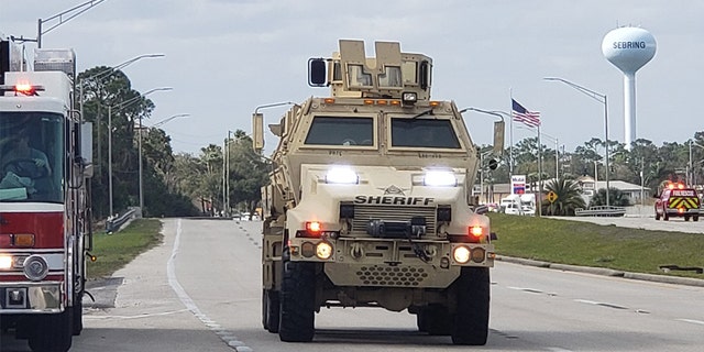A sheriff's department armored vehicle arrives at a SunTrust Bank branch, Wednesday, Jan. 23, 2019, in Sebring, Fla. Authorities say they've arrested a man who fired shots inside the Florida bank.