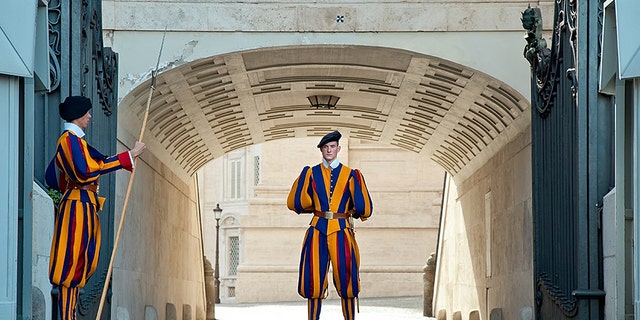 30 of April 2013. Rome, Vatican. Gate of St. Peter's Basilica which is guarded by Swiss Guards. The guard stands in the centre of the gate.