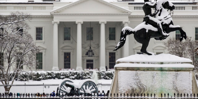 Snow blankets a statue of Andrew Jackson in Lafayette Square with the White House behind, as a winter storm arrives in the region, Sunday, Jan. 13, 2019, in Washington.