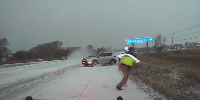 Deputy Jason Fabry was assisting a driver who slid into the ditch when an oncoming motorist lost control and nearly hit him.
