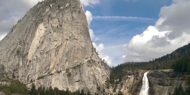 In this March 28, 2016, file photo provided by the National Park Service, water flows over the Nevada Fall near Liberty Cap as seen from the John Muir Trail in Yosemite National Park, Calif.
