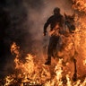 A man rides a horse through a bonfire as part of a ritual in honor of Saint Anthony the Abbot, the patron saint of domestic animals, in San Bartolome de Pinares, Spain, Jan. 16, 2019. 