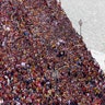 Philippine Coast Guard members keep watch as Roman Catholic devotees cross a bridge in a procession of the Black Nazarene to celebrate its feast day in Manila, Jan. 9, 2019. 