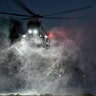 Snow is kicked up by the prop wash from the Marine One helicopter carrying President Trump, as it hovers over the snow-covered South Lawn landing at the White House, Jan. 14, 2019. 