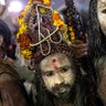 Indian Sadhus, or Hindu holy men, covered in ash walk before taking a ritualistic dip on auspicious Makar Sankranti day during the Kumbh Mela, or pitcher festival in Prayagraj, Uttar Pradesh state, India, Jan. 15, 2019. 