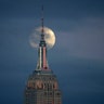 The rare phenomenon was visible in North and South America. In this photo the Moon is seen in its waxing gibbous stage as it rises behind the Empire State Building, Sunday, Jan. 20, 2019, seen from Jersey City, N.J.