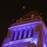 The Moon in total eclipse over Los Angeles City Hall.