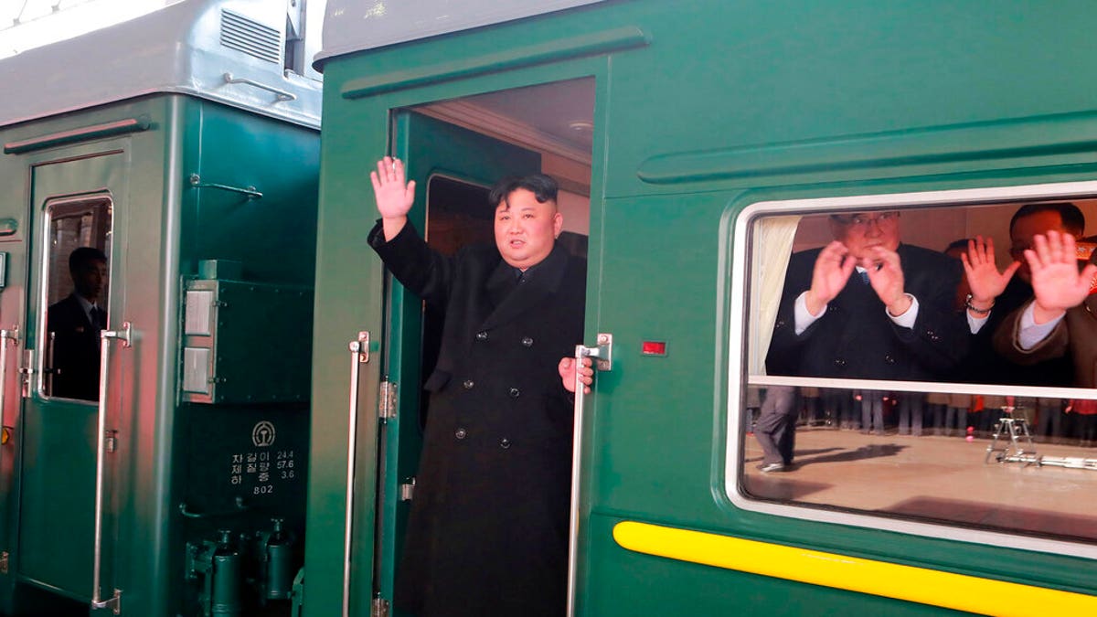 In this Saturday, Feb. 23, 2019, photo provided on Sunday, Feb. 24, 2019, by the North Korean government, North Korean leader Kim Jong Un waves from a train before leaving Pyongyang Station, North Korea, for Vietnam. 