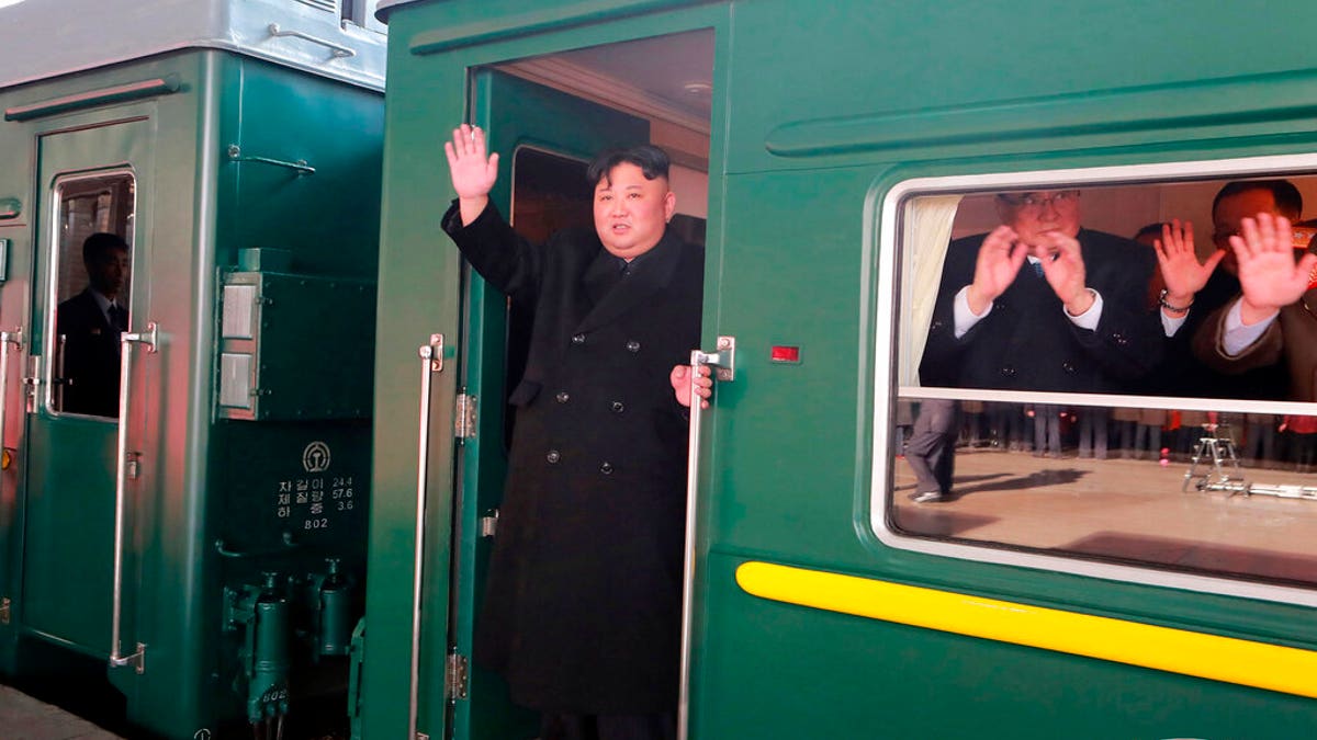 In this Saturday, Feb. 23, 2019, photo provided on Sunday, Feb. 24, 2019, by the North Korean government, North Korean leader Kim Jong Un waves from a train before leaving Pyongyang Station, North Korea, for Vietnam.