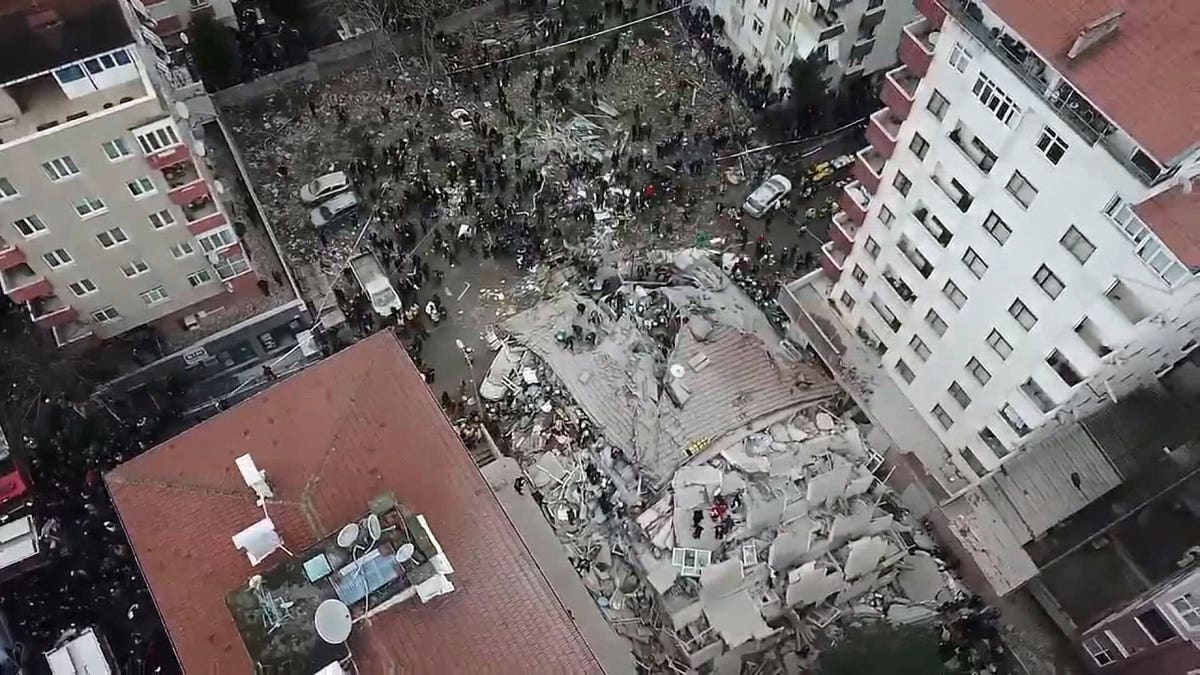 This frame made from video shows the site where a seven-story building collapsed, in Istanbul, Wednesday, Feb. 6, 2019. A seven-story building collapsed in Istanbul on Wednesday, killing at least one person and trapping several others inside the rubble, Turkish media reports said.