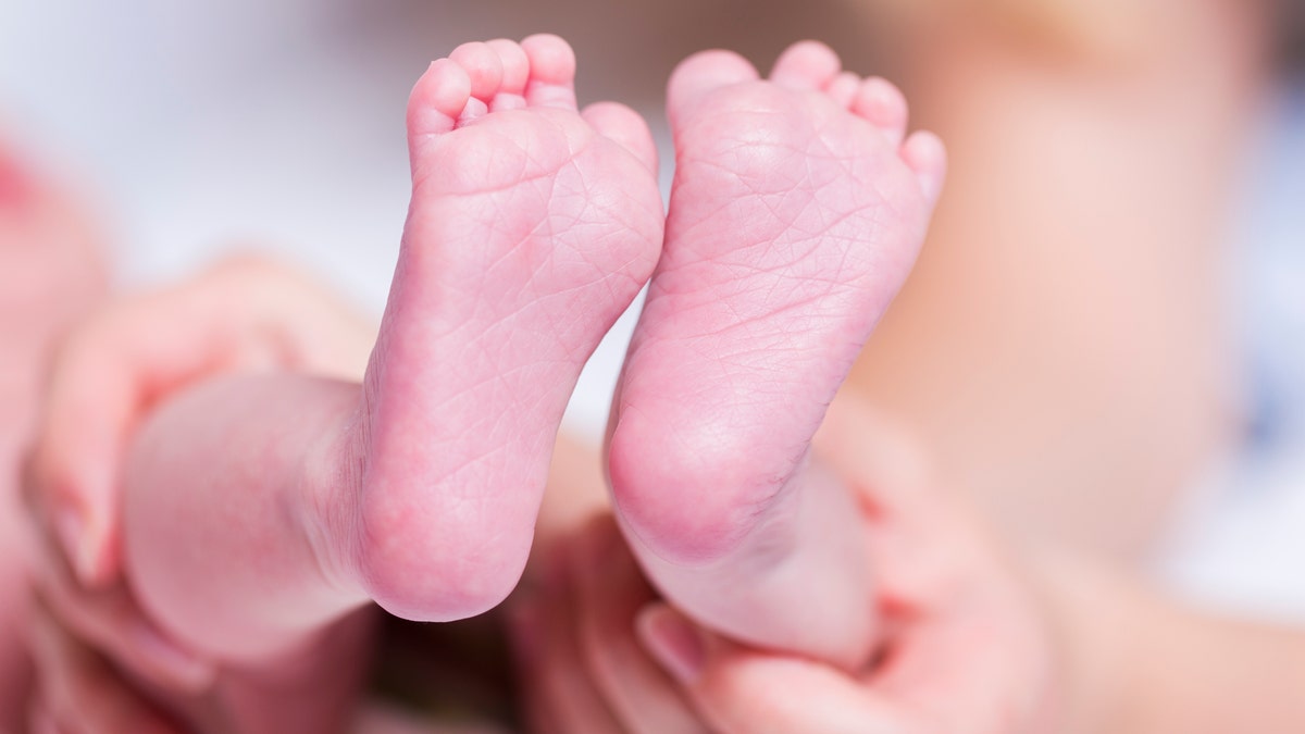 The baby's unclamped umbilical cord was still attached and he was bleeding, according to a report.