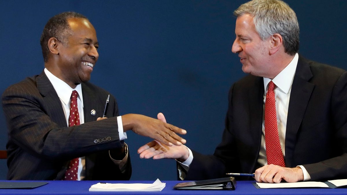 Housing and Urban Development Secretary Ben Carson, left, and New York Mayor Bill de Blasio shake hands after a ceremonial signing of an agreement about New York City's public housing system, the nation's largest, in New York, Thursday, Jan. 31, 2019. (