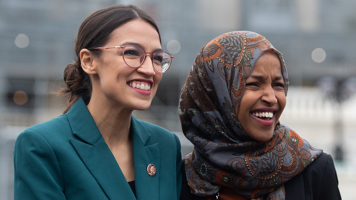 US Representative Alexandria Ocasio-Cortez, Democrat of New York, and US Representative Ilhan Omar (R), Democrat of Minnesota, attend a press conference calling on Congress to cut funding for US Immigration and Customs Enforcement (ICE) and to defund border detention facilities, outside the US Capitol in Washington, DC, February 7, 2019. (Photo by SAUL LOEB / AFP) (Photo credit should read SAUL LOEB/AFP/Getty Images)