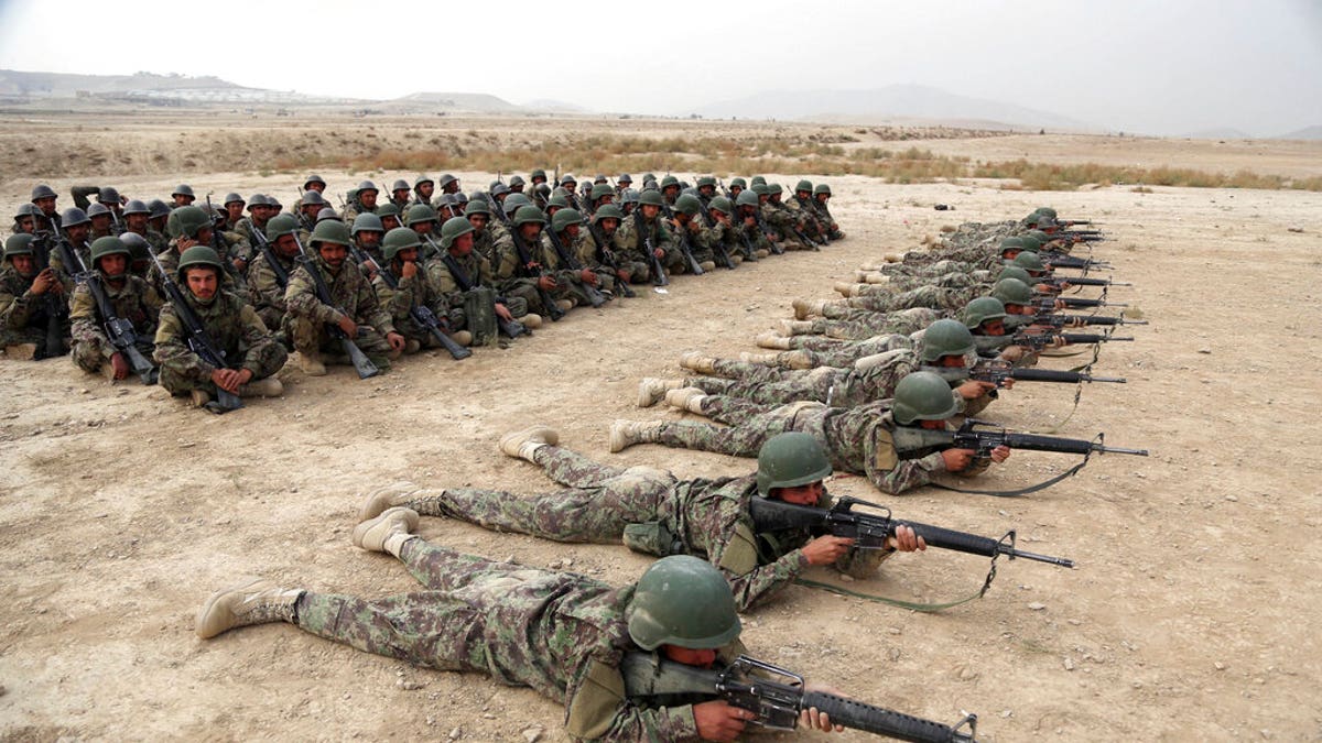 FILE - In this Oct. 31, 2018, photo, Afghan National Army (ANA) soldiers carry out an exercise during a live firing at the Afghan Military Academy in Kabul, Afghanistan. Trump administration claims of progress in talks with the Taliban have sparked fears even among allies of the president that his impatience with the war in Afghanistan will lead him to withdraw troops too soon, leaving the country at risk of returning to the same volatile condition that prompted the invasion in the first place. (AP Photo/Rahmat Gul, File)