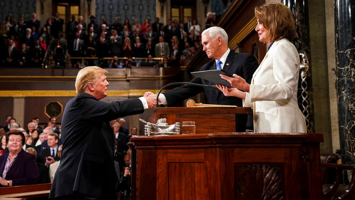 President Donald Trump shakes hands with Vice President Mike Pence, as House Speaker Nancy Pelosi looks on, as he arrives in the House chamber before giving his State of the Union address to a joint session of Congress, Tuesday, Feb. 5, 2019 at the Capitol in Washington. (Doug Mills/The New York Times via AP, Pool)