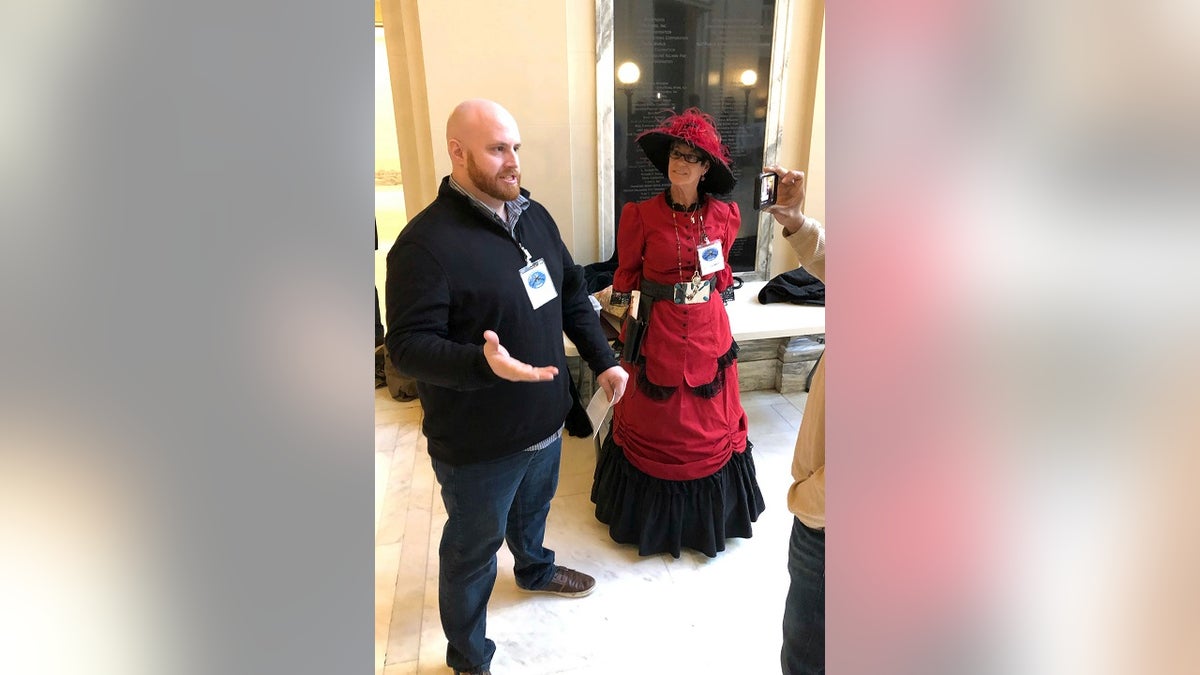 Alex Kearns and Belinda Barker, members of a pro-gun group, talk to a reporter, Thursday, Feb. 7, 2019, in Oklahoma City, after a House panel approved a bill that would allow Oklahomans to carry firearms without a permit, training or background check. (Associated Press)