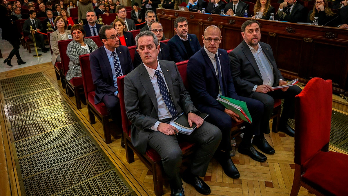 Front row from left, Joaquim Form, Raul Romeva, Oriol Junquera, second row from left, Josep Rull, Jordi Turull, Jordi Sanchez, third row from left, Dolors Bassa, Carmen Forcadell, Jordi Cuixart, back row from left, Meritxell Borras, Santiago Vila, and Carles Mundo during the trial at the Spanish Supreme Court in Madrid, Tuesday, Feb. 12.