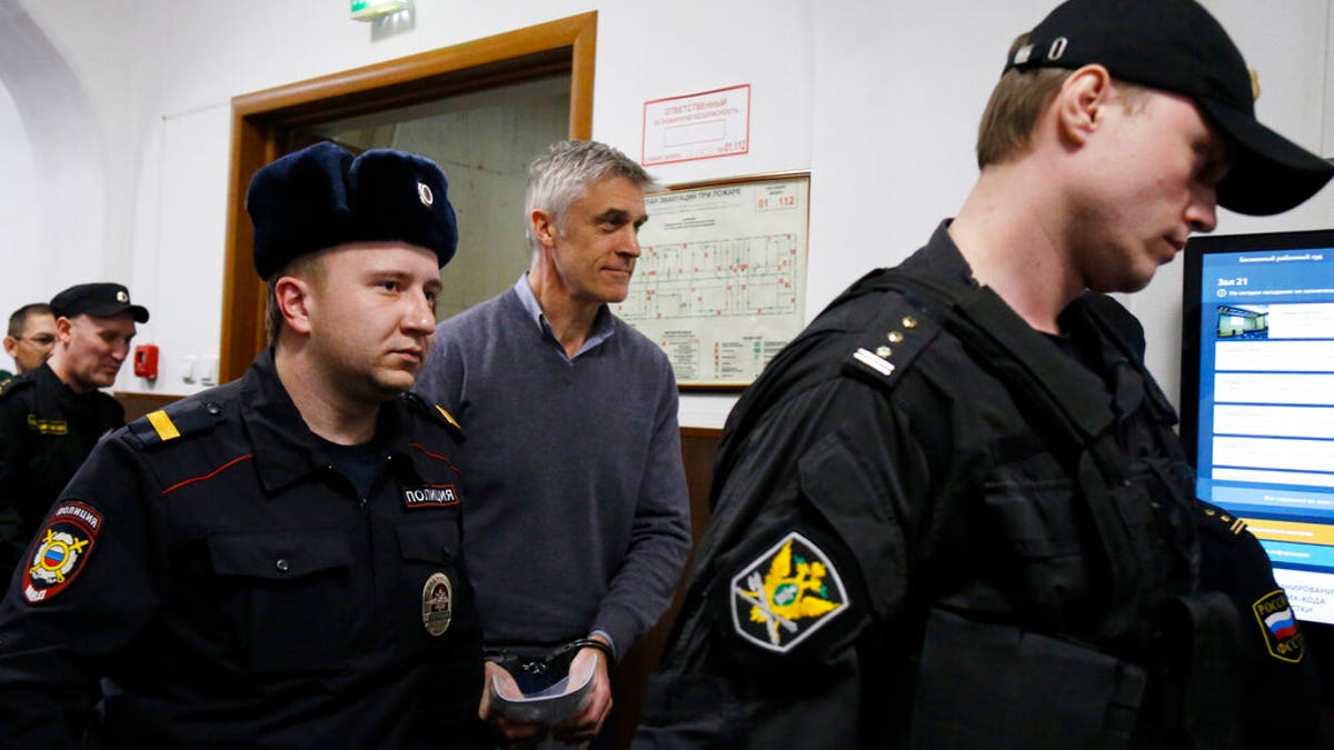 Founder of the Baring Vostok investment fund Michael Calvey, center, is escorted to the court room in Moscow, Russia, Friday, Feb. 15.