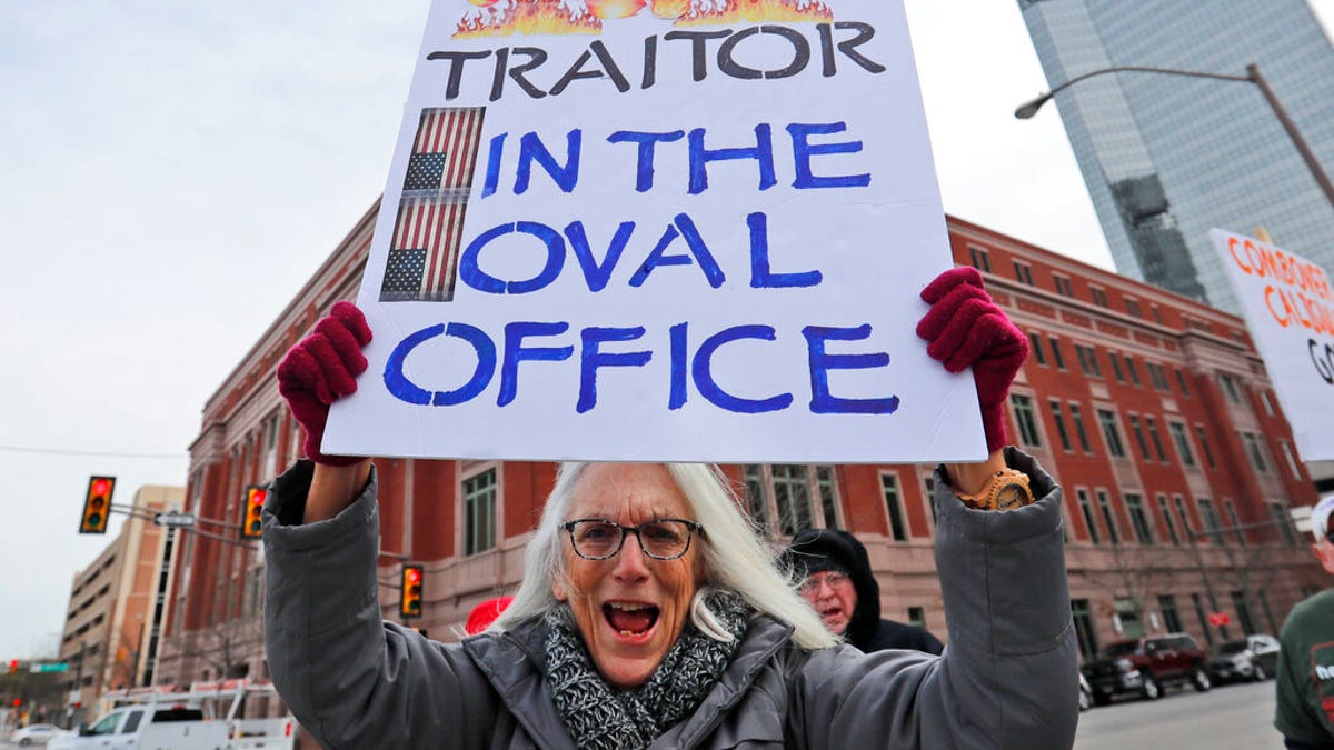 Cathy Clark holding a sign during a protest in downtown Fort Worth, Texas, on Monday. (AP Photo/LM Otero)