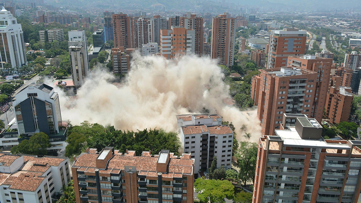Clouds of dust rise from the implosion of a six-floor apartment building that former cartel boss Pablo Escobar once called home, in Medellin, Colombia, Friday, Feb. 22, 2019. Mayor Federico Gutierrez had been pushing to raze the building and erect in its place a park honoring the thousands of victims, including four presidential candidates and some 500 police officers, killed by Escobar's army of assassins during the Medellin cartel's heyday in the 1980s and 1990s. (AP Photo/Luis Benavidez)