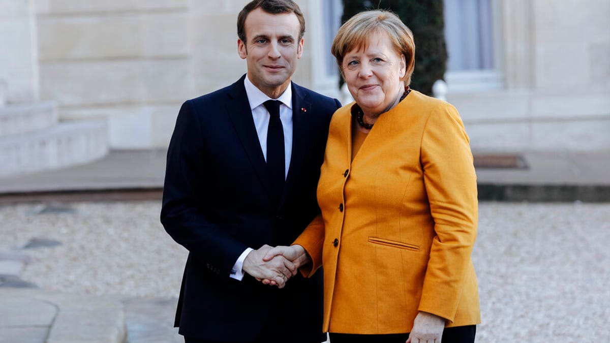 French President Emmanuel Macron, left, greets German Chancellor Angela Merkel prior to their meeting at the Elysee Palace in Paris, Wednesday, Feb. 27.