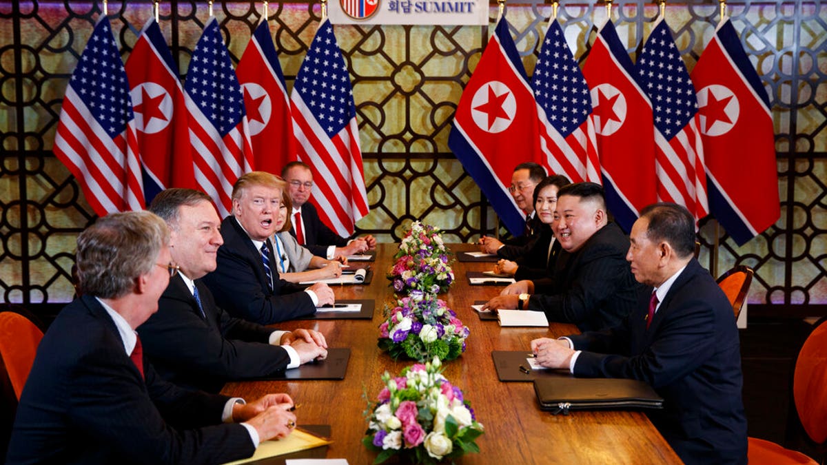 President Donald Trump speaks during a meeting with North Korean leader Kim Jong Un Thursday, Feb. 28, 2019, in Hanoi. At front right is Kim Yong Chol, a North Korean senior ruling party official and former intelligence chief. At left is national security adviser John Bolton and Secretary of State Mike Pompeo, second from left.