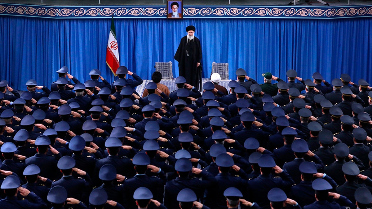 In this picture released by an official website of the office of the Iranian supreme leader, Supreme Leader Ayatollah Ali Khamenei stands as army air force staff salute at the start of their meeting in Tehran, Iran, Friday, Feb. 8, 2019. Khamenei is defending "Death to America" chants that are standard fare at anti-U.S. rallies across Iran but says the chanting is aimed at America's leaders and not its people. (Office of the Iranian Supreme Leader via AP)