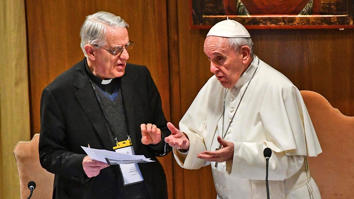 Pope Francis speaks with Rev. Federico Lombardi, left, the former Vatican spokesman who is moderating the summit, at the opening of a sex abuse prevention summit, at the Vatican, Thursday, Feb. 21, 2019. The gathering of church leaders from around the globe is taking place amid intense scrutiny of the Catholic Church's record after new allegations of abuse and cover-up last year sparked a credibility crisis for the hierarchy. (Vincenzo Pinto/Pool Photo via AP)