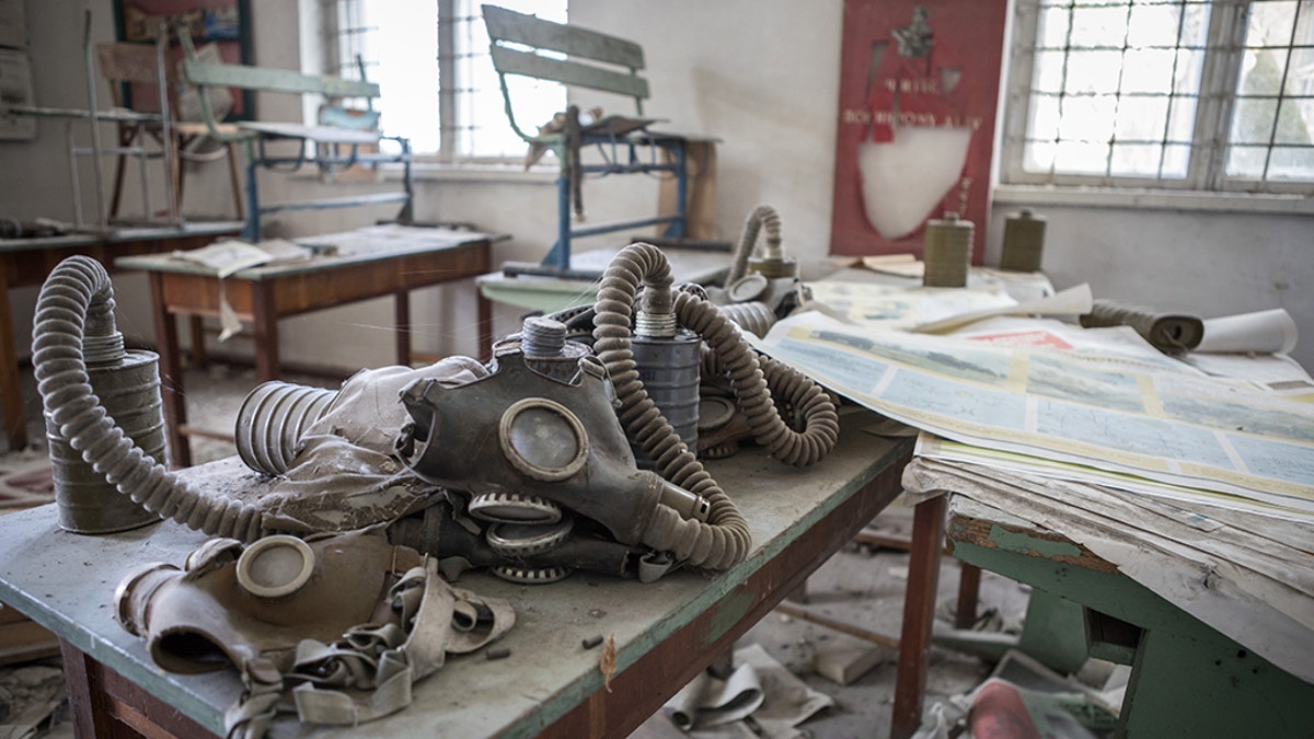 Gas masks left on a school desk. (Credit: Media Drum World)