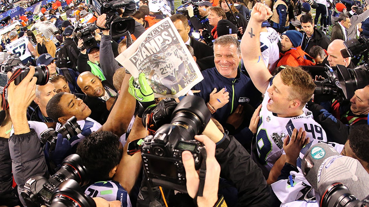 EAST RUTHERFORD, NJ - FEBRUARY 02: Long snapper Clint Gresham #49 of the Seattle Seahawks celebrates with teammates on the field after winning Super Bowl XLVIII at MetLife Stadium on February 2, 2014 in East Rutherford, New Jersey. The Seahawks beat the Broncos 43-8.