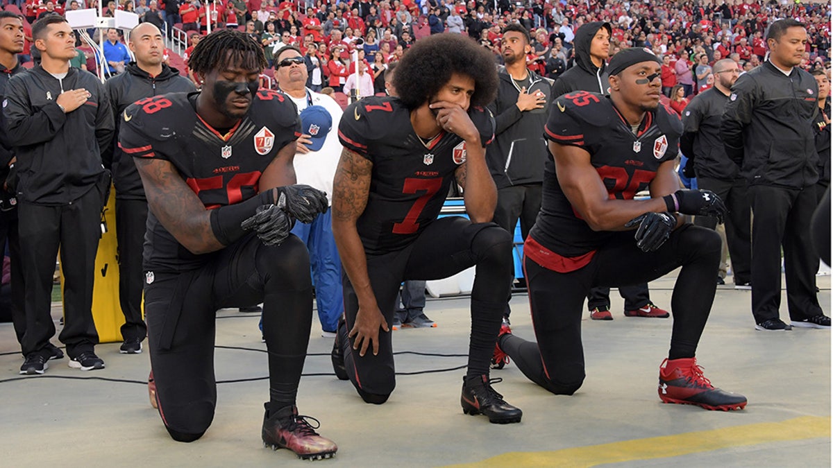 San Francisco 49ers linebacker Eli Harold (58), quarterback Colin Kaepernick (7) and free safety Eric Reid (35) kneel in protest during the playing of the national anthem before a NFL game in 2016. (USA TODAY Sports) 