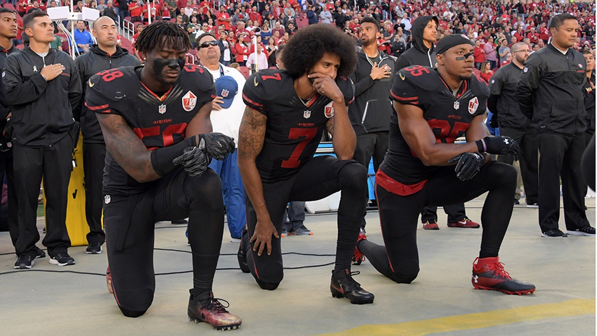 San Francisco 49ers linebacker Eli Harold (58), quarterback Colin Kaepernick (7) and free safety Eric Reid (35) kneel in protest during the playing of the national anthem before a NFL game in 2016. (USA TODAY Sports)