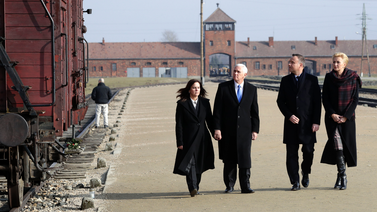 United States Vice President Mike Pence and his wife Karen Pence, left, walk with Poland's President Andrzej Duda and his wife Agata Kornhauser-Duda, right, during their visit at the Nazi concentration camp Auschwitz-Birkenau.