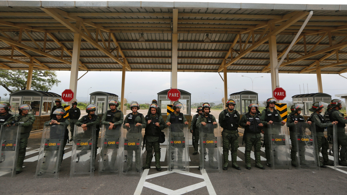 Venezuelan Bolivarian Guardsmen stand guard at the Tienditas International Bridge that links Colombia and Venezuela, near Urena, Venezuela, Friday, Feb. 8, 2019. As humanitarian aid kits were being packed into individual white bags in the city of Cucuta, just across the river from Venezuela, U.S. officials and Venezuelan opposition leaders appealed to the military to the let the aid through. (AP Photo/Fernando Llano)