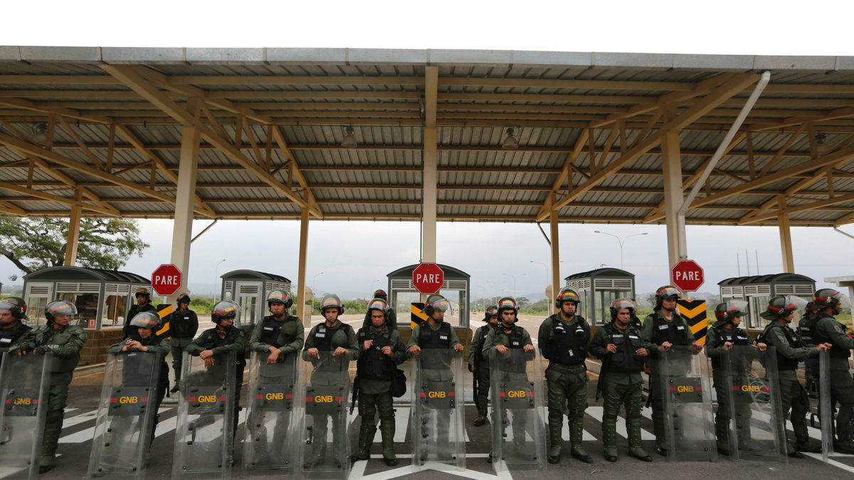 Venezuelan Bolivarian Guardsmen stand guard at the Tienditas International Bridge that links Colombia and Venezuela, near Urena, Venezuela, Friday, Feb. 8, 2019. As humanitarian aid kits were being packed into individual white bags in the city of Cucuta, just across the river from Venezuela, U.S. officials and Venezuelan opposition leaders appealed to the military to the let the aid through. (AP Photo/Fernando Llano)