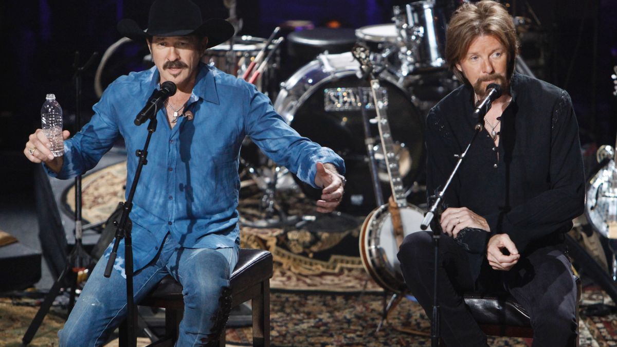 In this Aug. 12, 2009, file photo, Kix Brooks, left, and Ronnie Dunn of the country music duo Brooks & Dunn talk about their decision to stop performing together as they answer questions from the audience during a television taping in Nashville, Tenn. (AP Photo/Mark Humphrey)