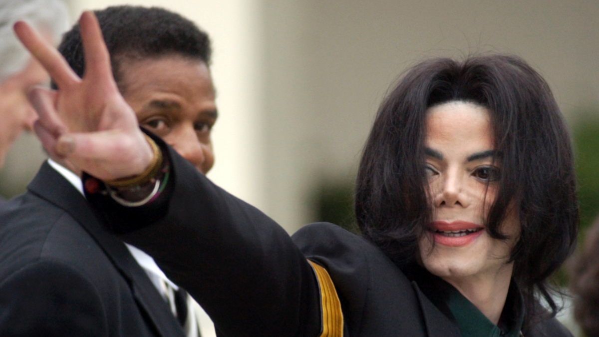 In this March 2, 2005 photo, pop icon Michael Jackson waves to his supporters as he arrives for his child molestation trial at the Santa Barbara County Superior Court in Santa Maria, Calif. The estate of Michael Jackson on Thursday sued HBO over a documentary about two men who accuse the late pop superstar of molesting them when they were boys, saying the film violates a 1992 contract to air a Jackson concert. The lawsuit filed in Los Angeles County Superior Court alleges that by co-producing and airing "Leaving Neverland," the cable channel is committing breach of contract and breach of covenant, citing a section of the deal for “Michael Jackson in Concert in Bucharest: The Dangerous Tour” that states HBO would not disparage Jackson at the time or in the future. 