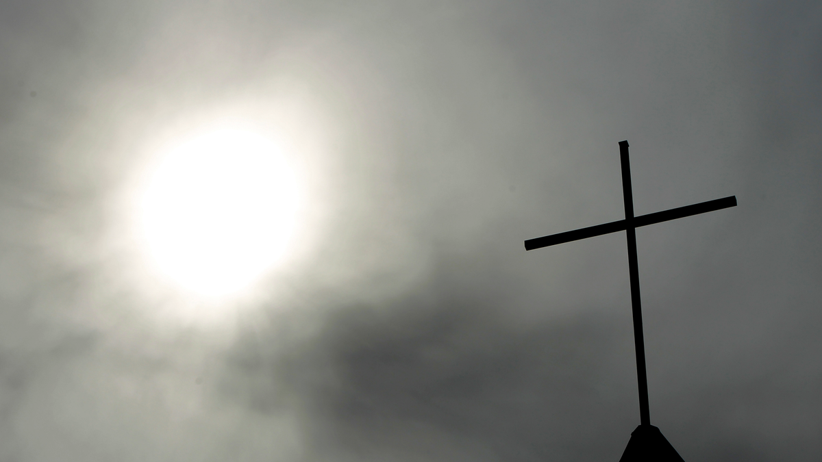 A cross sits on top of a church in Berlin, Germany. Pope Francis' high-stakes sex abuse prevention summit is meant to call attention to the crisis as a global problem that requires a global response. (AP Photo/Markus Schreiber, File)