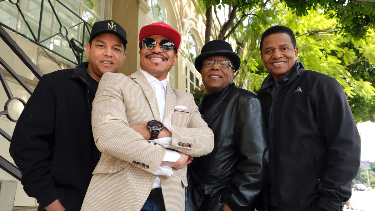 In this Tuesday, Feb. 26, 2019, Marlon Jackson, second from left, Tito Jackson, second from right, and Jackie Jackson, far right, brothers of the late musical artist Michael Jackson, and Tito's son Taj, far left, pose together for a portrait outside the Four Seasons Hotel, in Los Angeles. Jackie, Tito, Marlon and Taj Jackson, gave the first family interviews Tuesday on “Leaving Neverland,” which features two Michael Jackson accusers and is set to air on HBO starting Sunday, March 3. (Photo by Chris Pizzello/Invision/AP)