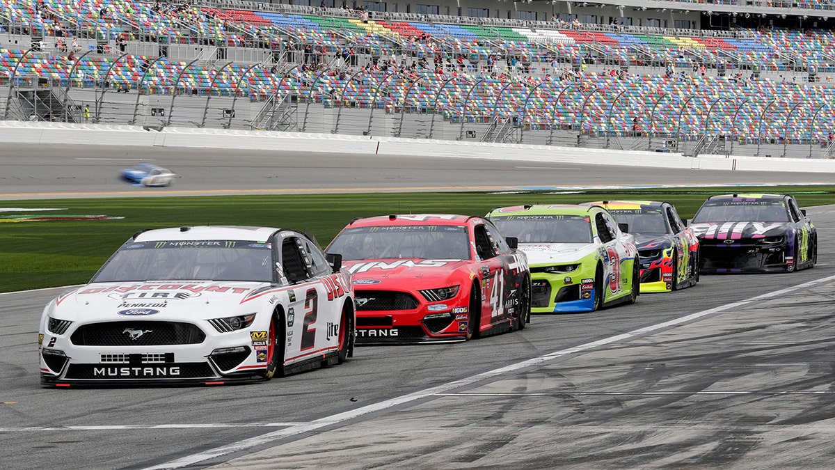 NASCAR drivers, from left, Brad Keselowski (2), Daniel Suarez (41), Tyler Reddick, William Byron and Jimmie Johnson wait on pit road for their turn on the track during auto racing practice for the Daytona 500 at Daytona International Speedway in Florida, Saturday. (AP Photo/John Raoux)