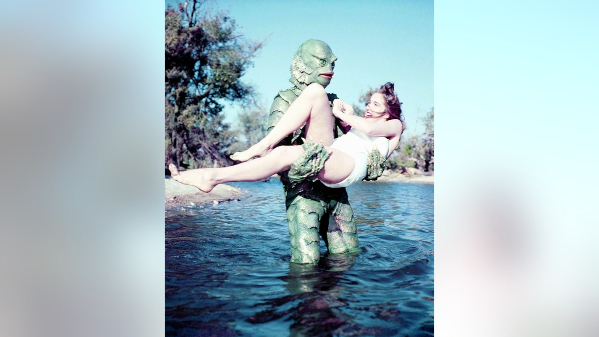 American actors Ben Chapman (1928 - 2008) as Gill-man, and Julie Adams as Kay Lawrence, in "Creature From the Black Lagoon," directed by Jack Arnold, 1954.