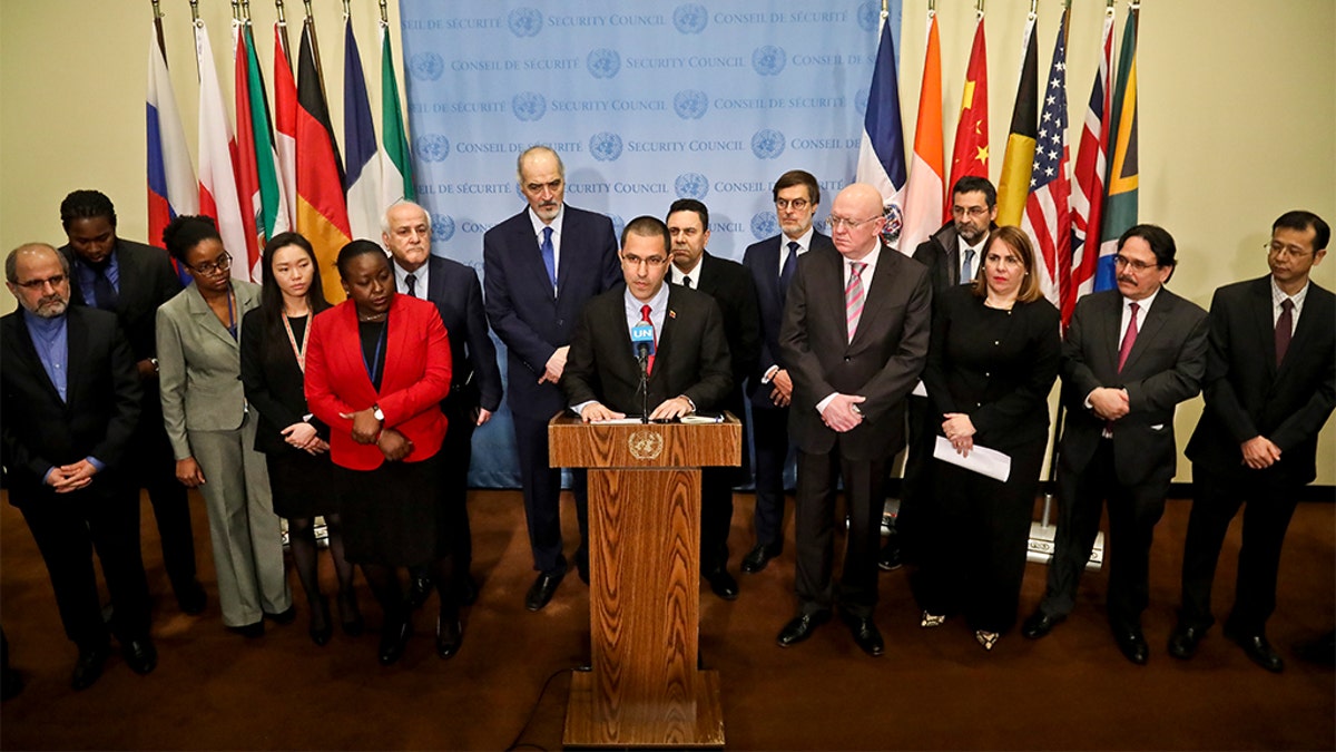 Venezuela Foreign Affairs Minister Jorge Arreaza, center, surrounded by diplomats from several countries including Russia, China, Iran and Syria, at Thursday's announcement. (AP Photo/Bebeto Matthews)