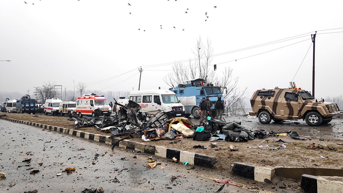 Indian soldiers examine the debris after an explosion in Lethpora in south Kashmir's Pulwama district February 14, 2019.