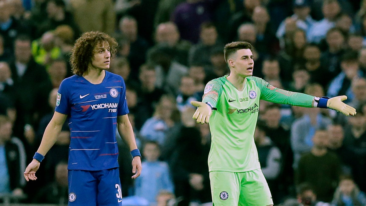 Chelsea goalkeeper Kepa Arrizabalaga, right, gesturing to the bench as captain David Luiz looked on during Sunday's League Cup final against Manchester City. (AP Photo/Tim Ireland)