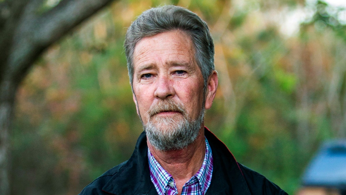 In this Dec. 5, 2018 file photo, Leslie McCrae Dowless Jr. poses for a portrait outside of his home in Bladenboro, N.C. The North Carolina political operative at the center of a ballot fraud scandal is facing criminal charges for his activities in the 2016 elections and the Republican primary in 2018. Wake County District Attorney Lorrin Freeman said Wednesday, Feb. 27, 2019, that Dowless was arrested after grand jury indictments alleging illegal possession of absentee ballots and obstruction of justice. (Travis Long/The News & Observer via AP, File)
