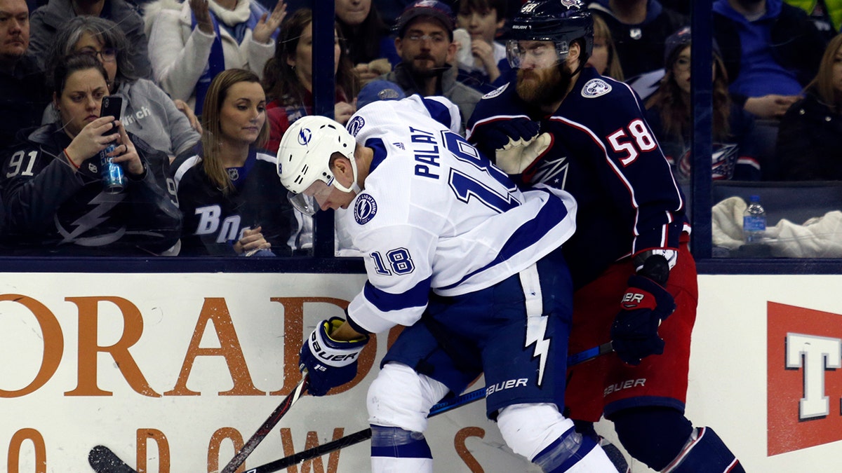 Tampa Bay Lightning forward Ondrej Palat, left, of the Czech Republic, works against Columbus Blue Jackets defenseman David Savard during the second period of an NHL hockey game in Columbus, Ohio, Monday, Feb. 18, 2019.